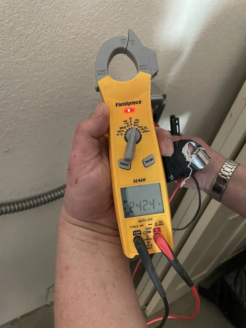 Voltage testing with clamp meter during Outlet Installation in Milbank